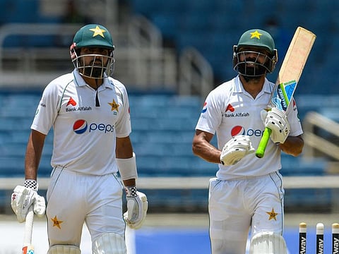 Pakistan captain Babar Azam (left) and Fawad Alam walk off the field during their recovery act on first day of the second Test against West Indies at Sabina Park, Kingston, Jamaica, on Friday.