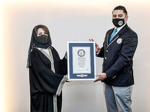 Maitha Bin Adai (left), CEO of Traffic and Roads Agency, RTA, receives the Guinness World Record certificate
