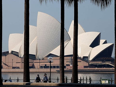 Police officers patrol in front of the Sydney Opera House, as the city extended its two-month-old lockdown and introduced a partial curfew to contain a fast-spreading coronavirus outbreak.
