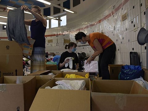 Civilian volunteers sort donations for evacuees from Afghanistan at Ramstein Air Base, Germany on August 22, 2021.
