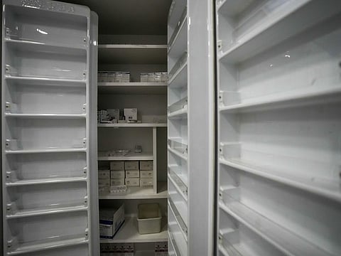 Almost empty shelves seen at the medical storage of the government-run Rafik Hariri University Hospital in Beirut, Lebanon, Wednesday, Aug. 11, 2021. Many private hospitals, who offer 80% of Lebanon's medical services, are shutting down because of lack of resources or turning away patients who can't pay. (AP Photo/Hassan Ammar)