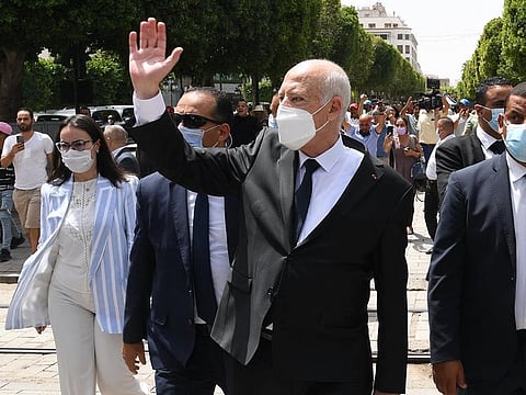 Tunisia President Kais Saied (C) gestures as he walks protected by security while touring through Habib Bourguiba avenue in the centre of the capital Tunis.