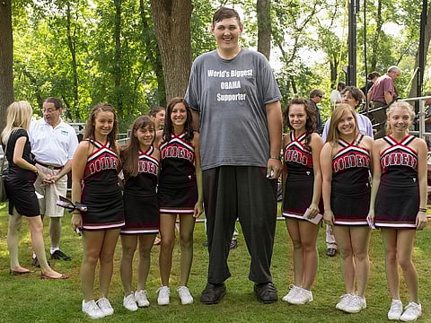 File photo: Seven-foot, eight-inch tall, Igor Vovkovinskiy (centre), seen with cheerleaders.