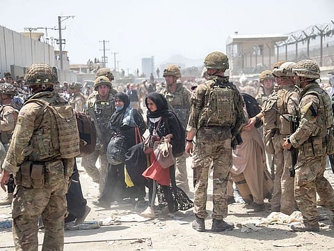 Members of the British and US Armed Forces working at Kabul Airport.