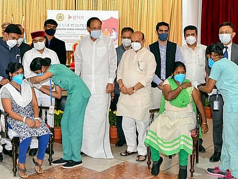 Beneficiaries receive COVID-19 vaccine dose in the presence of India's Vice-President Venkaiah Naidu, Karnataka Chief Miinister Basavaraj Bommbai and Governor Thaawarchand Ghelot, during 'Vaccinate India Progamme' organised by Give India Foundation in association with the State Government, at Raj Bhavan in Bengaluru, on August 24, 2021.