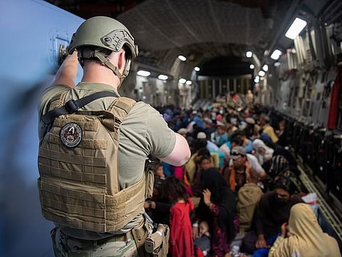 A US Air Force security forces raven, assigned to the 816th Expeditionary Airlift Squadron, maintains security aboard a US Air Force C-17 Globemaster III aircraft in support of the Afghanistan evacuation at Hamid Karzai International Airport in Kabul, Afghanistan, August 24, 2021.