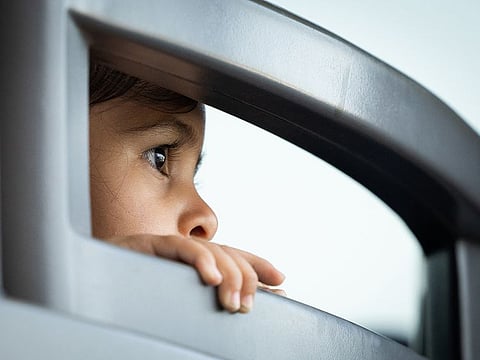A young Afghan refugee on a bus at Dulles International Airport in Dulles, Virginia, Thursday, Aug. 26, 2021, en route to a nearby processing center.