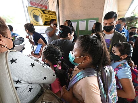 Students and parents arrive masked for the first day of the school year at Grant Elementary School in Los Angeles, California.