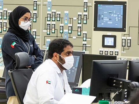 Female Emirati nuclear reactor operator Hind with her colleague Abdullah at the Unit 2 of the Barakah Nuclear Energy Plant.