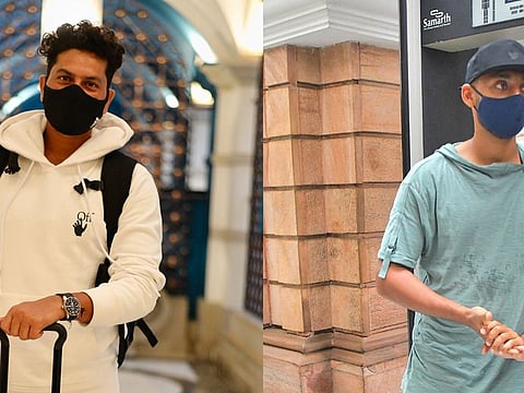 Spin twins: Kuldeep Yadav (left) and Varun Chakravarthy are masked up for their trip to Abu Dhabi on Thursday.