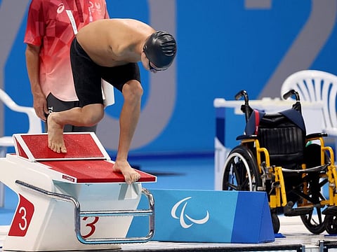 Refugee Paralympic Team's Afghan-origin Abbas Karimi competes in the men's 50m butterfly S5 category heat during the Tokyo 2020 Paralympic Games on Friday.