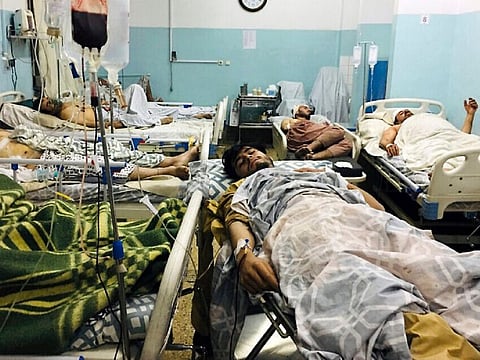 Wounded Afghans lie on a bed at a hospital after a deadly explosion outside the airport in Kabul, Afghanistan, Thursday, Aug. 26, 2021.
