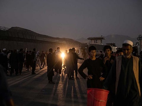 People are sent away from the scene of a bomb blast outside the Hamid Karzai International Airport in Kabul, Afghanistan on Thursday, Aug. 26, 2021.