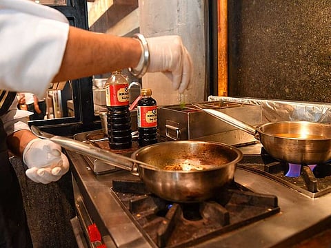 In this picture taken on July 16, 2021 a chef prepares a samosa filling with mince meat prepared with Kikkoman Soy Sauce at the Ishaara restaurant in Mumbai.