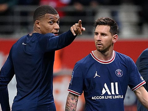Kylian Mbappe talks to Lionel Messi at the end of the match.