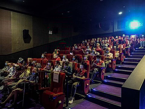 Visually impaired people listening to the film narrator during a screening at a cinema in Beijing.