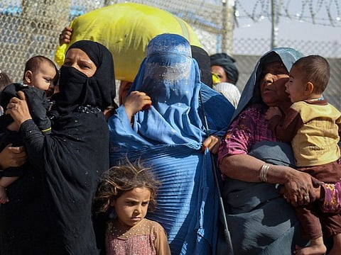Afghan nationals arrive in Pakistan through the border crossing point in Chaman.