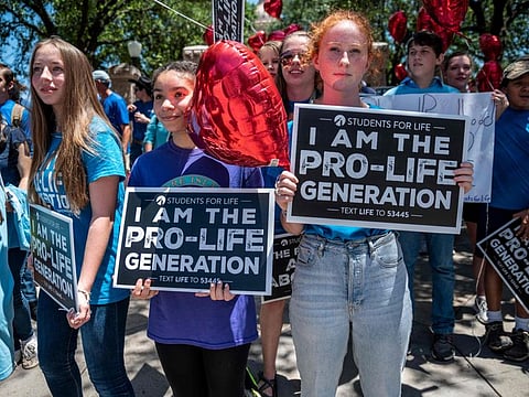 In this file photo pro-life activists stand near the gate of the Texas state capitol during a protest in Austin, Texas.