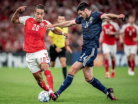 Scotland's defender Scott McKenna (right) fights for the ball with Denmark's forward Yussuf Yurary Poulsen during their the FIFA World Cup Qatar 2022 qualification match in Copenhagen.