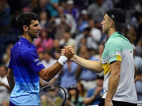 Serbia's Novak Djokovic greets the Netherland's Tallon Griekspoor at the net after winning their 2021 US Open Tennis tournament men's singles second round match at the USTA Billie Jean King National Tennis Center in New York.