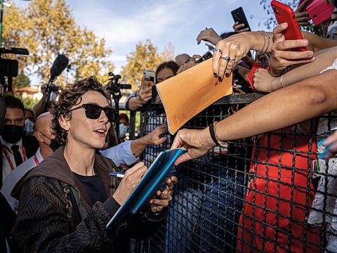 Actor Timothée Chalamet signs autographs upon arrival for the photo call of the film 'Dune' at the 78th edition of the Venice Film Festival in Venice, Italy, Friday, Sep, 3, 2021.