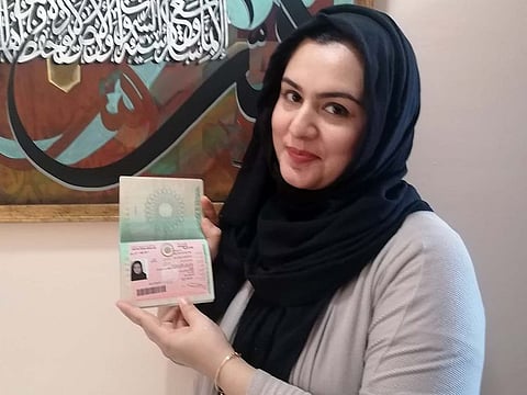 Pakistani expatriate woman Rubab Zahra displays her UAE Golden Visa.