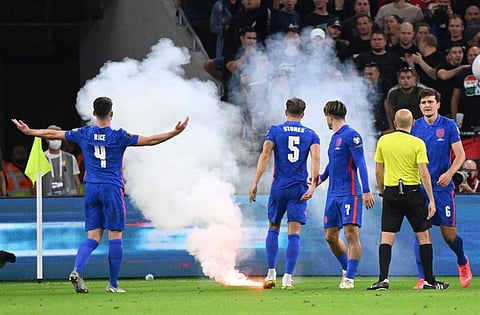 Players react as the game is interrupted due to flares landing on the pitch during the FIFA World Cup Qatar 2022 qualification Group I football match between Hungary and England, at the Puskas Arena in Budapest.