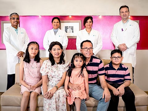 Eliza Aurelia Tubil and her husband and three school-going children with the doctors who treated her