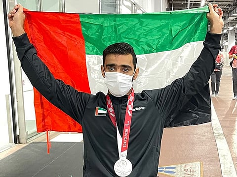 Mohammed Al Hammadi displays the UAE flag after winning the silver medal on Saturday.