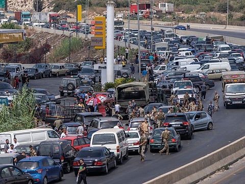 A view of a petrol station on the main highway that links Beirut to south Lebanon as cars come from every direction to try and fill their tanks with petrol, in the coastal town of Jiyeh, south of Beirut, on September 3, 2021.
