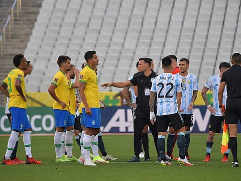 Argentina and Brazil players are seen after employees of the National Health Surveillance Agency (Anvisa) came onto the field during the South American qualification football match for the FIFA World Cup Qatar 2022.