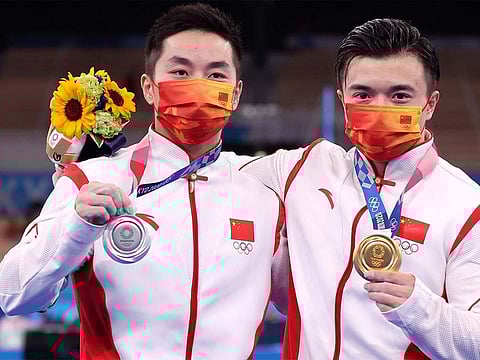 Liu Yang (R) and You Hao of China celebrate after the men's rings final at the Tokyo Olympics in Tokyo, Japan, August 2, 2021