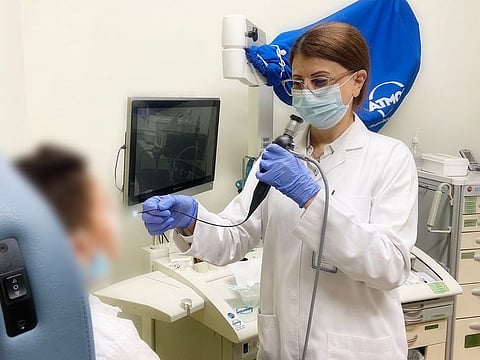 Dr Mai Naif Al Shoufi, ENT Specialist, treating the boy