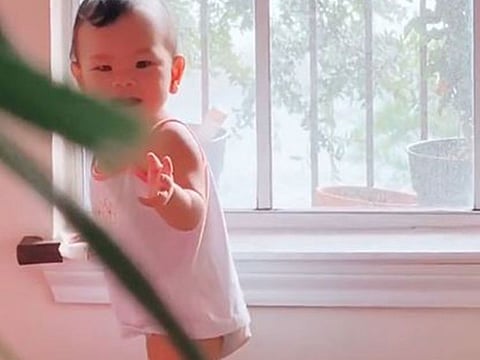 Quacey turns and faces the camera with a big smile across her face