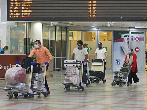 Egyptian expats, who are fully vaccinated against COVID-19, arrive at Kuwait international airport in Kuwait City on September 5, 2021. A passenger who arrived in Kuwait has tested positive for the Delta variant of COVID-19 after he had undergone a PCR test upon arrival.