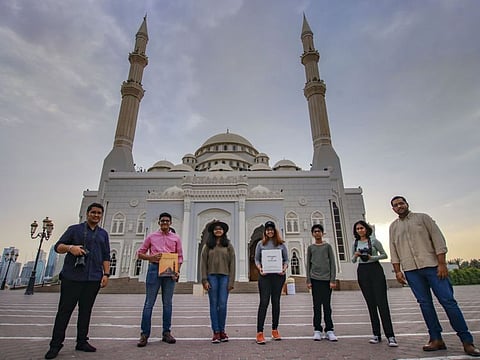 Joseph lenju, Joseph Alex, Hanna Alex, Sara Alex, Smaran Nicholas , Smarnika Nicole, Alex Lenju, pose for the picture in front of Al Noor Mosque in Sharjah. Seven Christian students from the Indian community working on a coffee table book with unique photographs of mosques in Sharjah as a token of gratitude towards the Sharjah Rulers’ generosity towards their community.
