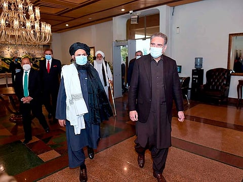 Pakistani Foreign Minister Shah Mehmood Qureshi (right) with Taliban co-founder Mullah Abdul Ghani Baradar in Islamabad (File)