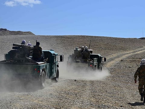 Afghan resistance movement and anti-Taliban uprising forces personnel patrol in armoured humvees at an outpost in Kotal-e Anjuman of Paryan district in Panjshir province.
