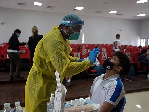 A child undergoing a PCR test at an Abu Dhabi school following the launch of in-school testing on September 7