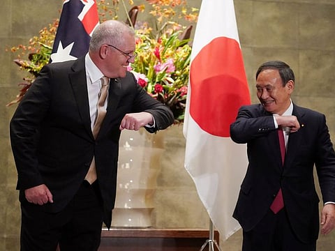 Australian Prime Minister Scott Morrison greets Japan's Prime Minister Yoshihide Suga in a file photo.