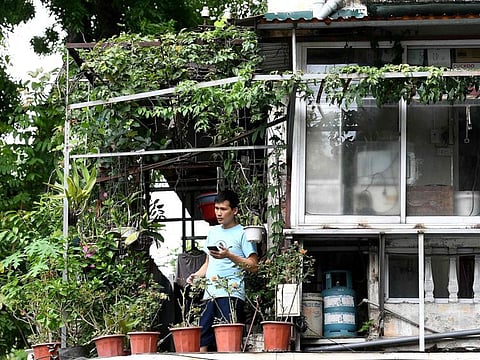 A man stands on the balcony of his home in Hanoi, during the government-imposed lockdown to stop the spread of the COVID-19 on September 3.