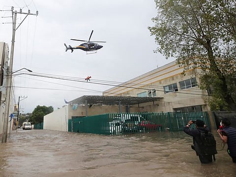 A police helicopter arrives to rescue a patient from a flooded hospital in Tula de Allende.