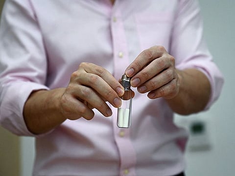 Assistant professor Chadin Kulsing from Chulalongkorn University's chemistry department demonstrating how sweat samples are collected, as his team develops a novel device that detects COVID-19 through specific odors, in Bangkok.