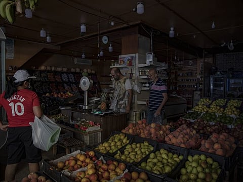 A customer shops in a grocery store during a power cut in Beirut on September 7, 2021. Egypt agreed to supply natural-gas to Lebanon through Jordan and Syria as the Arab states seek to help end power shortages in their crisis-ridden neighbour.