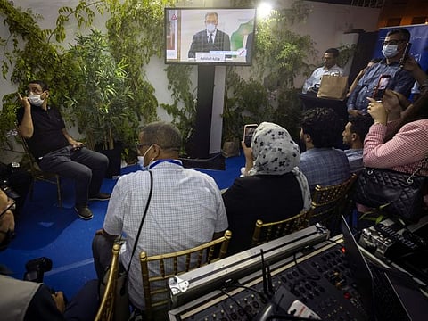 Journalists watch a television broadcast of Morocco's Minister of the Interior Abdul Ouafi Laftit announcing the results of the country's parliamentary and local elections in Rabat early on September 9, 2021.