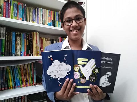 Sanith Santhasa Piyadigamage, the Year 9 student at The Winchestor School in Jebel Ali, with the three books authored by him.