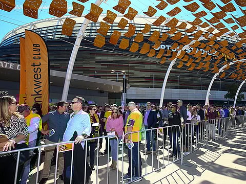 Fans lineup to enter the stadium ahead of the Rugby Championship game between the All Blacks and the Wallabies in Perth, Australia.