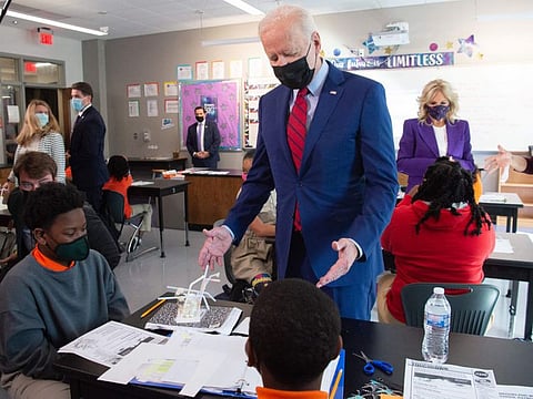US President Joe Biden speaks with students in a 6th grade science class during a visit to speak about COVID-19 protections in schools at Brookland Middle School in Washington, DC, September 10, 2021.
