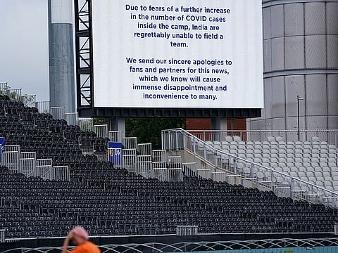 A message is displayed on a screen at Old Trafford cricket ground announces the postponement of the fifth and final Test match between England and India