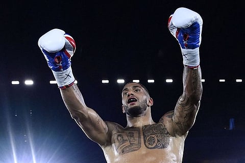 France's Tony Yoka celebrates after winning by technical knock out against Croatia's Petar Milas in their International heavyweight boxing match at the Roland-Garros complex in Paris.